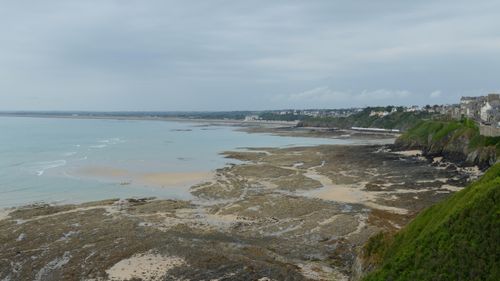 Free Beautiful view of the rocky coastline in Granville, Normandie under cloudy skies. Stock Photo