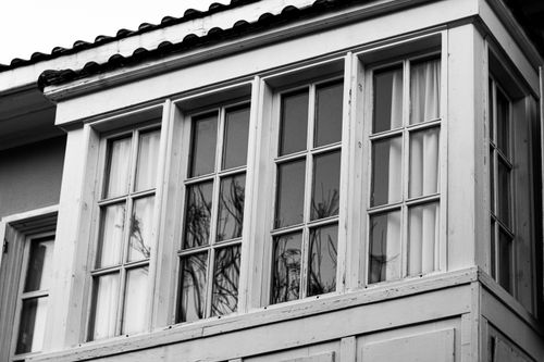 Free A classic black and white photograph of a traditional window with reflections on glass. Stock Photo