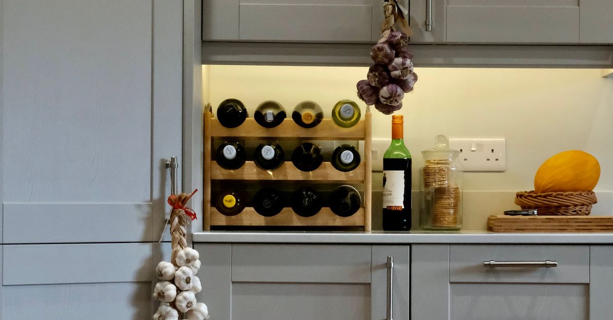 Cozy Kitchen Interior with Wine Rack and Garlic · Free Stock Photo