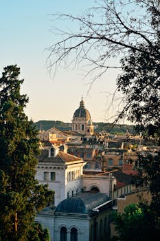 Stunning view of Rome's historic architecture during a vibrant sunset, capturing Italy's timeless beauty.