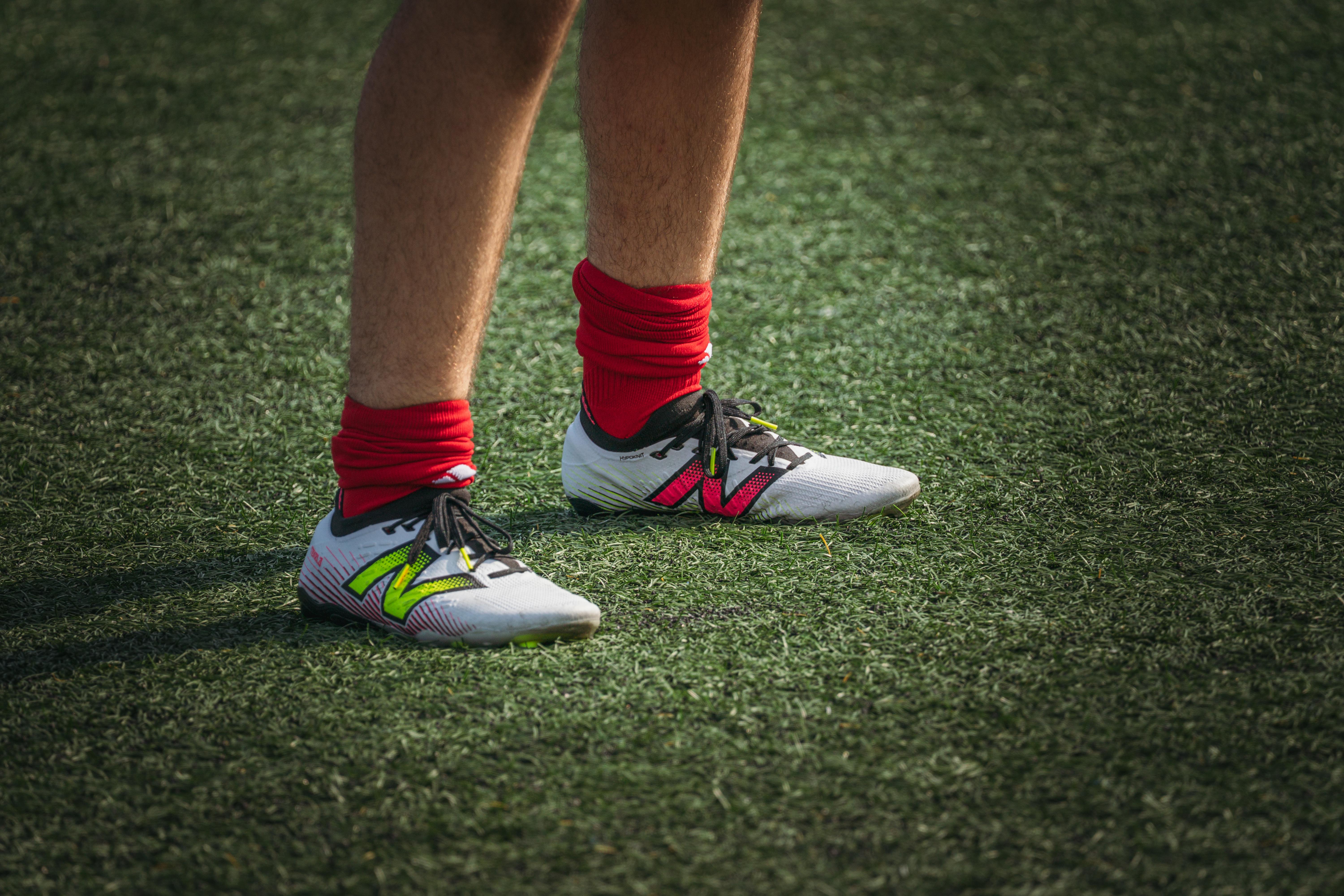 modern football field with players and vibrant synthetic turf