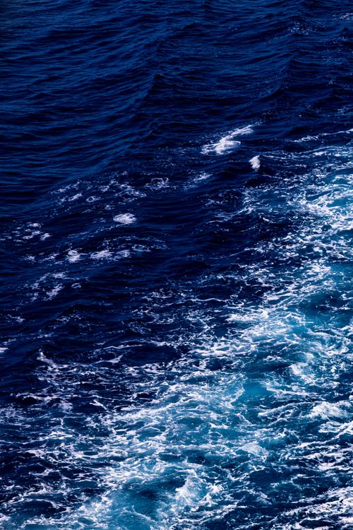 Free Dynamic blue ocean waves captured off the coast of Barcelona, Spain. Stock Photo