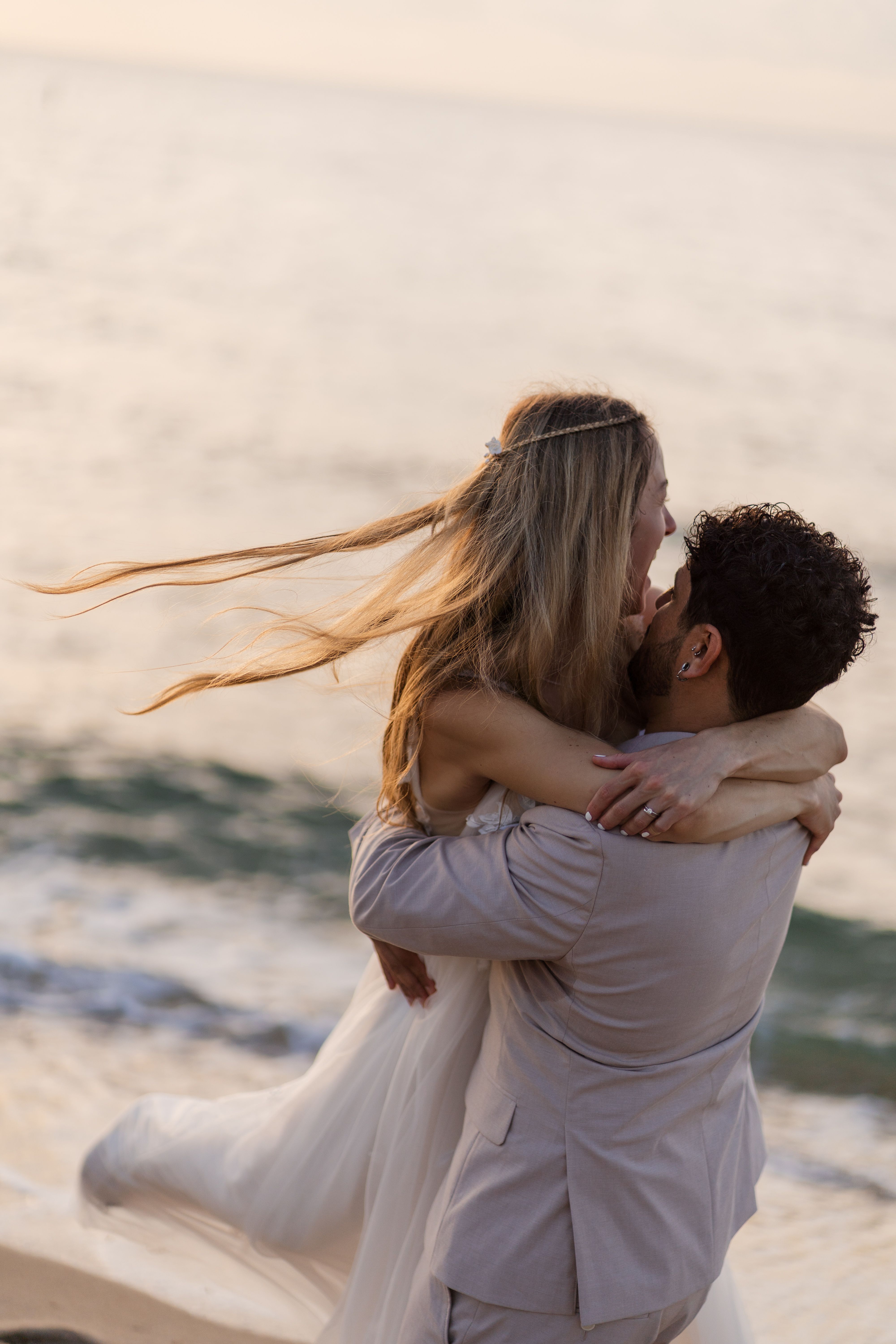 Romantic Beach Wedding Embrace at Sunset · Free Stock Photo