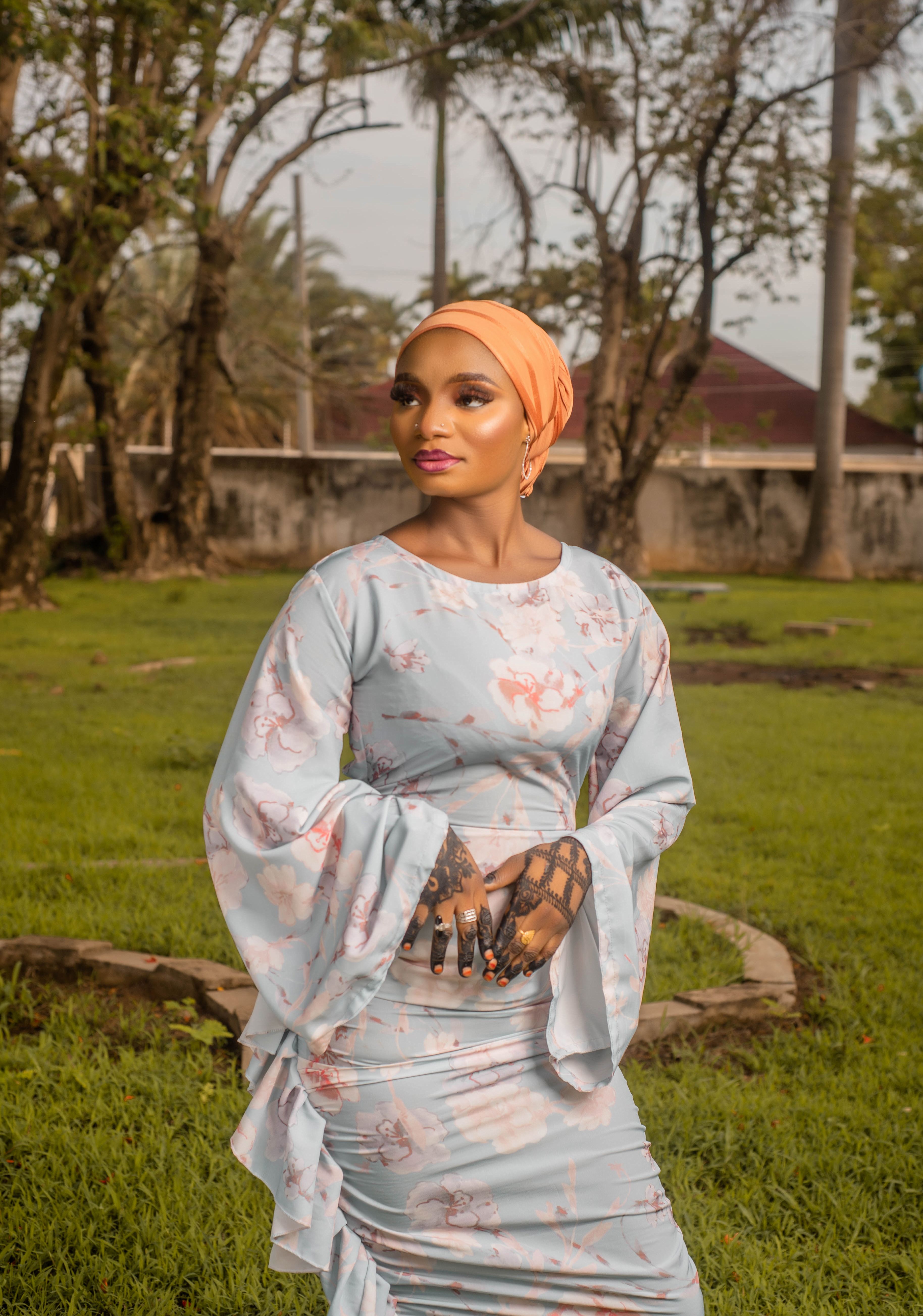Elegant Woman in Floral Dress Outdoors · Free Stock Photo