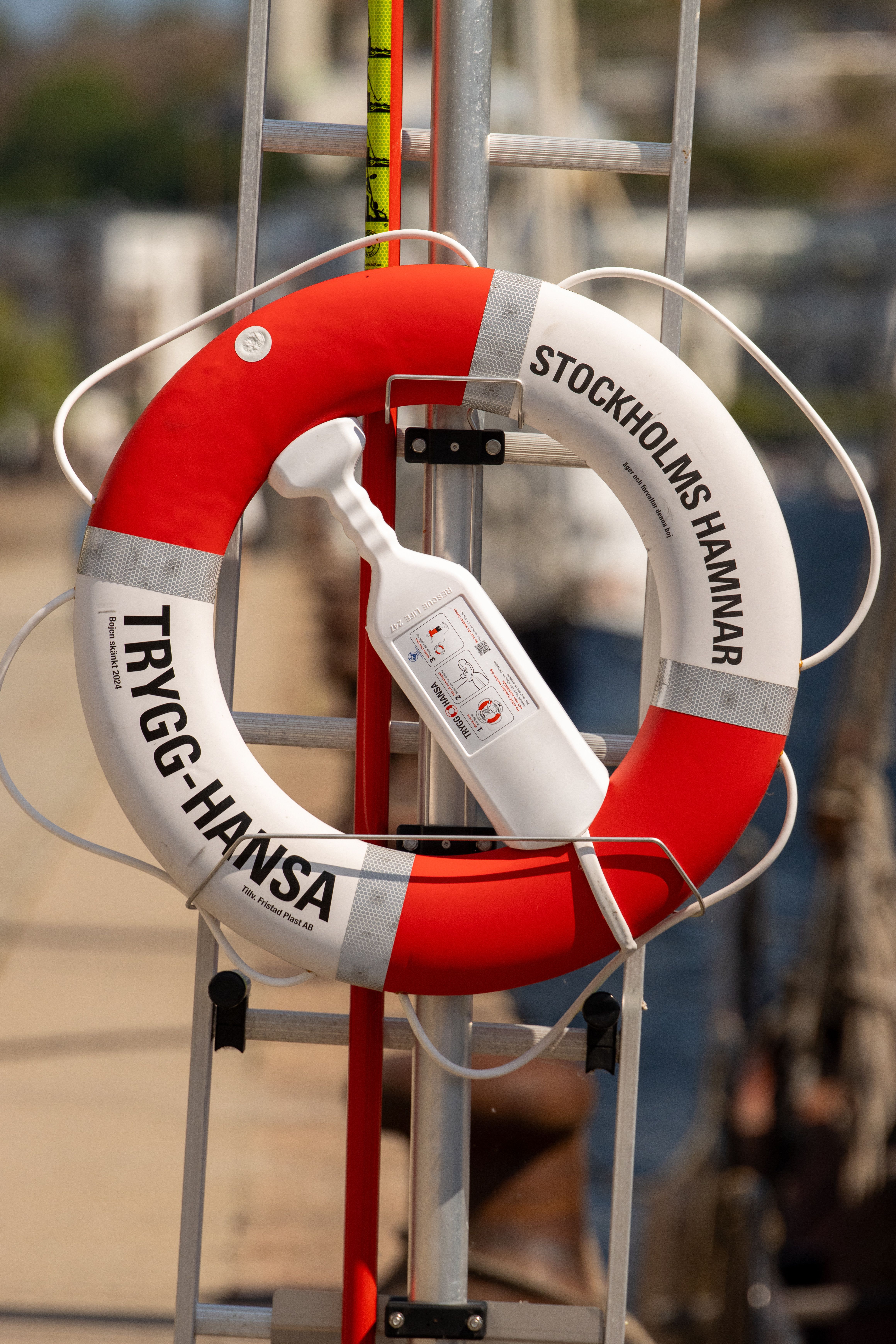 Close-up of a lifesaver ring labeled 'Stockholms Hamnar' on a dock in Stockholm.