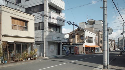Free A picturesque street in Kyoto, showing traditional storefronts and urban architecture. Stock Photo