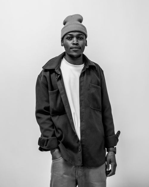 Free A stylish black and white portrait of a young man in casual attire, exuding confidence. Stock Photo