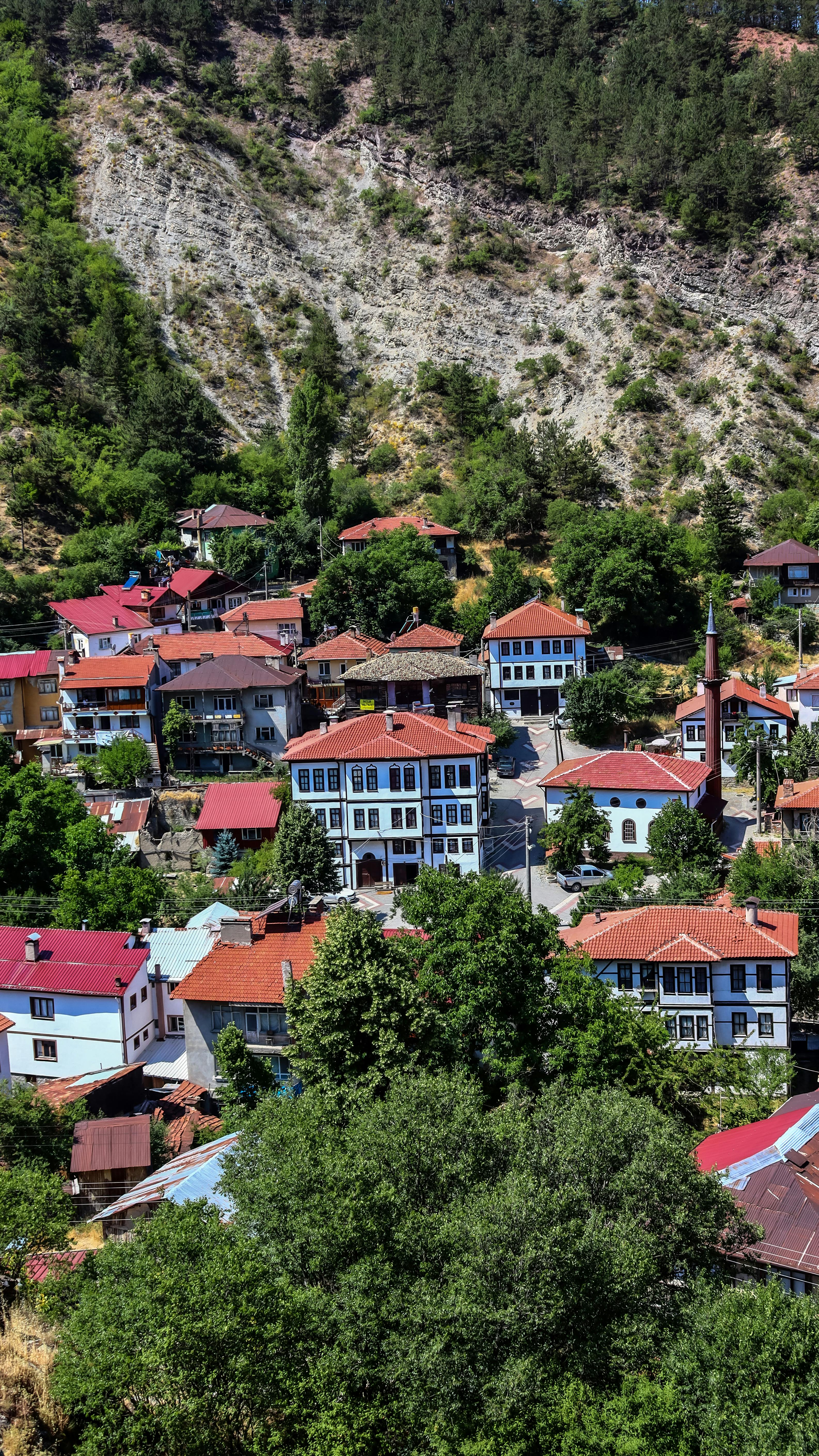 Scenic view of Mudurnu village with traditional rooftops set against lush hills in Bolu, Türkiye.