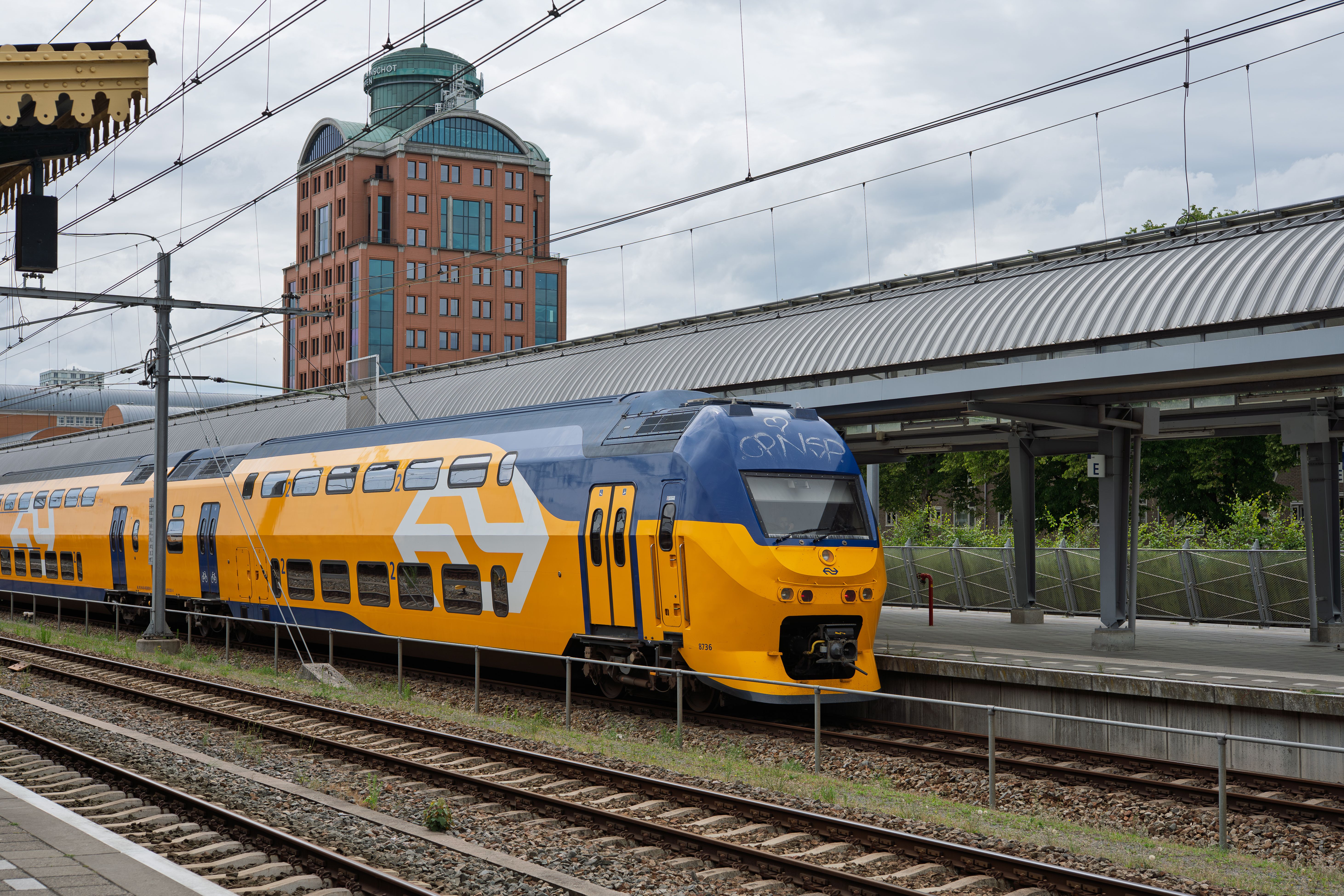 Yellow and Blue Train at Urban Platform · Free Stock Photo