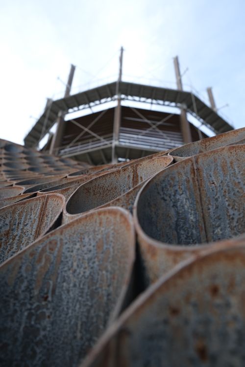 Free Abstract close-up of metal structure with honeycomb pattern under a building construction. Stock Photo