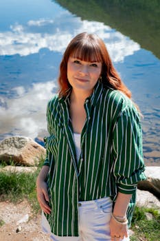 Woman posing by a serene mountain lake in Georgetown, Colorado, during a sunny summer day.
