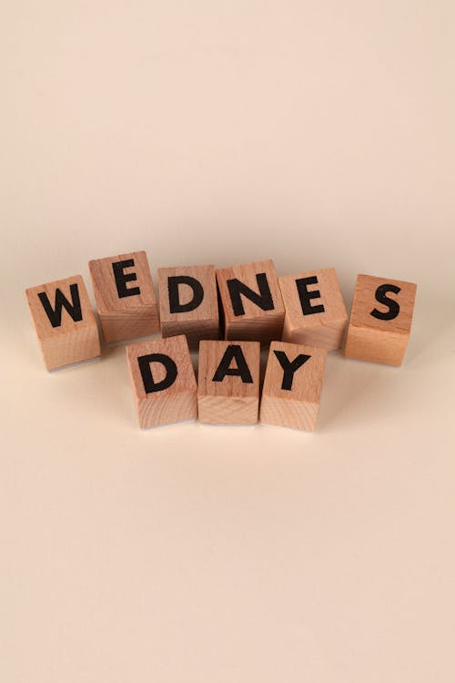 Wooden Blocks Spelling Wednesday on Beige Background · Free Stock Photo