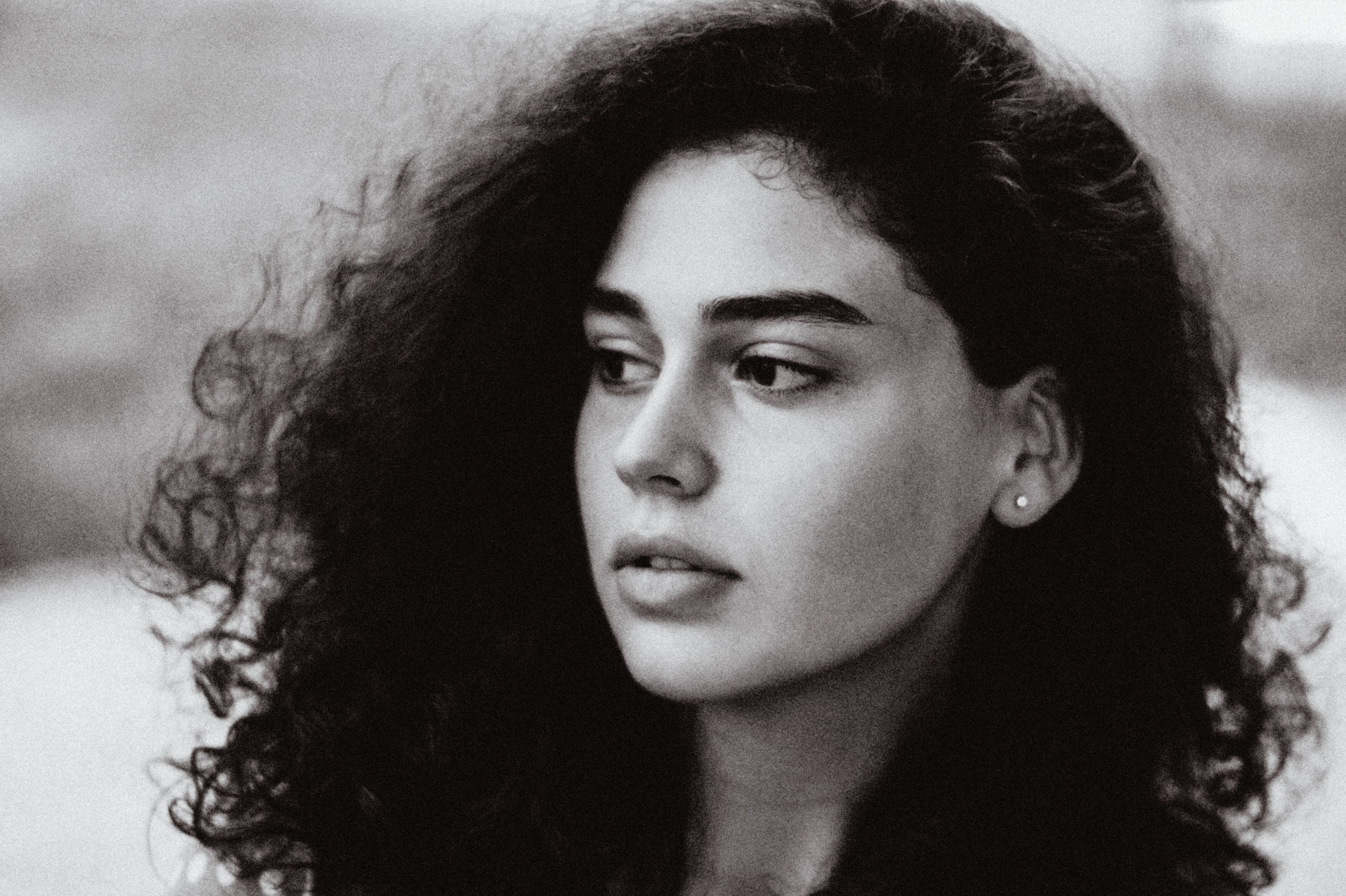 Artistic black and white portrait capturing the elegance and depth of a young woman\'s expression.