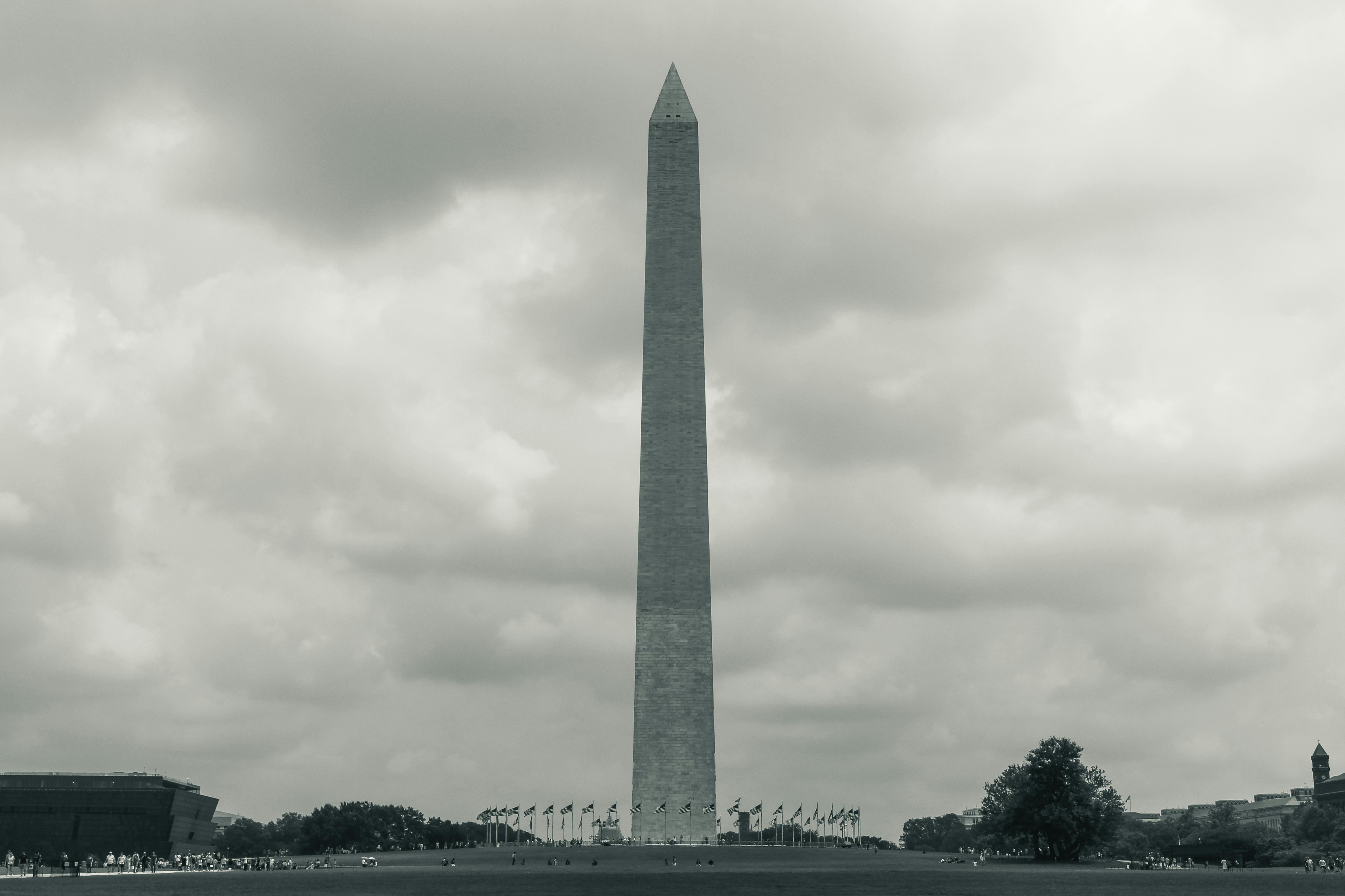 Black and white photograph of the Washington Monument in Washington D.C. with cloudy skies.
