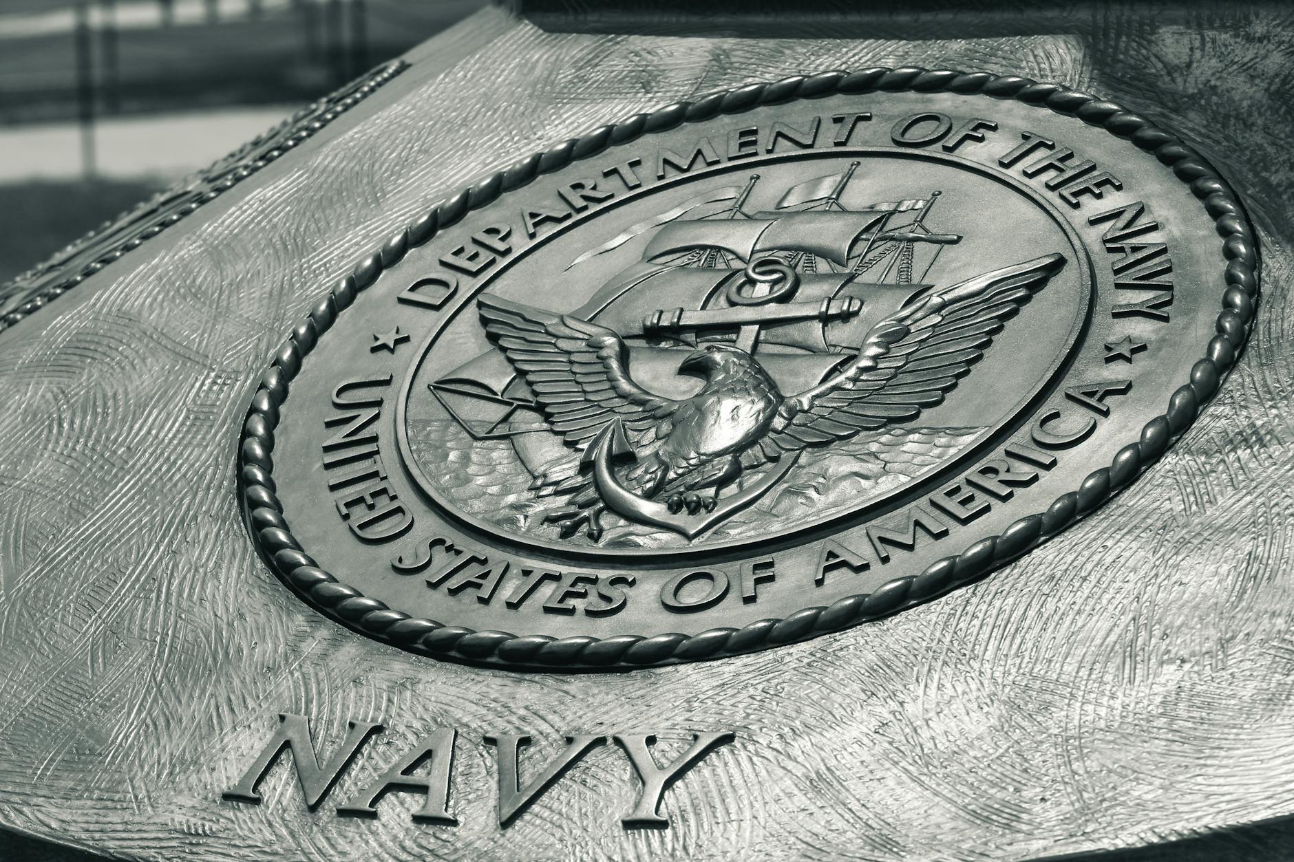 Detailed view of the United States Navy emblem on a monument in Washington D.C., showcasing naval heritage.