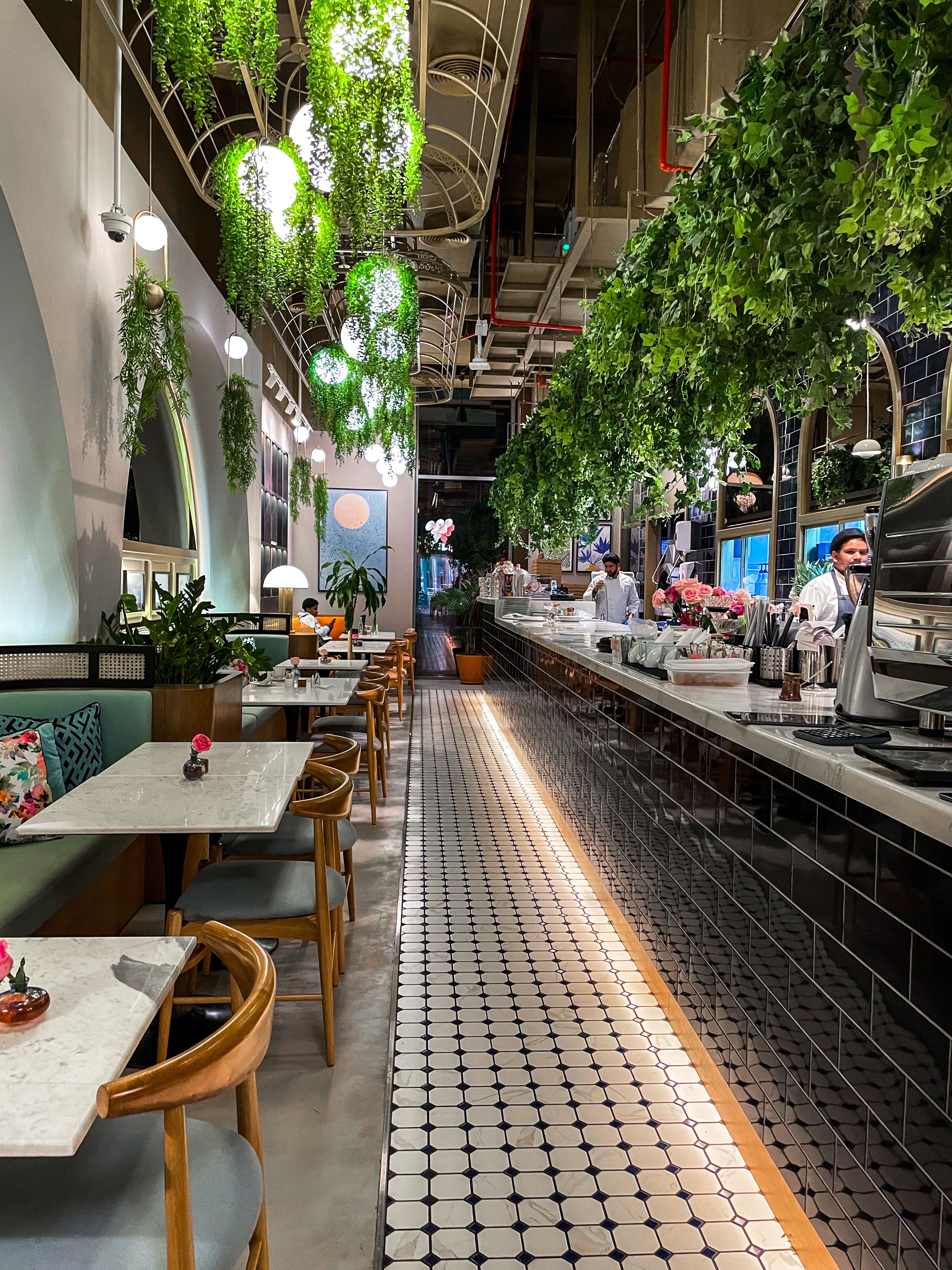 Modern cozy restaurant interior with greenery · Free Stock Photo