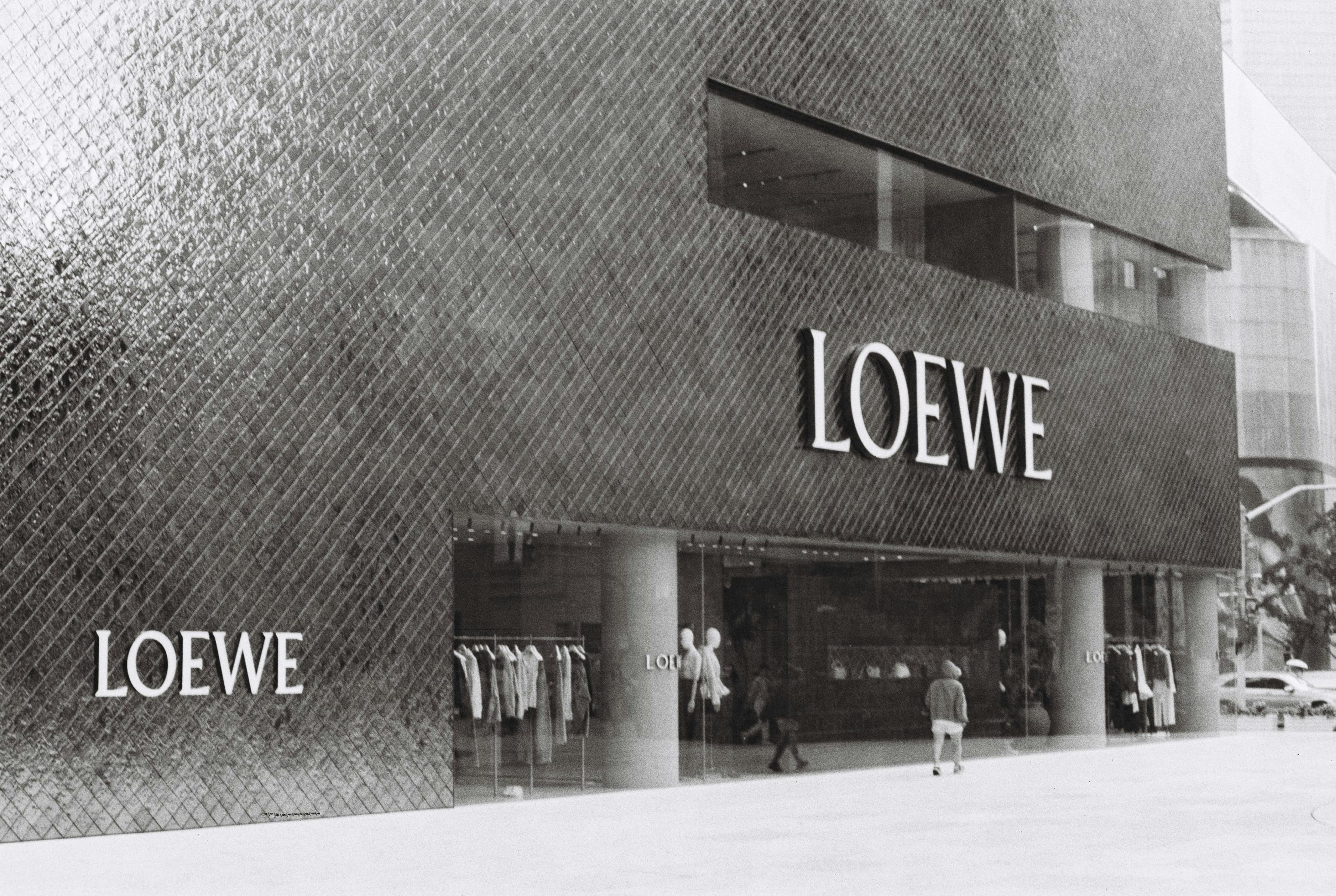 Retail store interior with modern clothing racks and premium brand logo