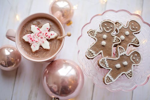 Free Top View Of Gingerbread on Glass Tray Beside A Cup of Drink And Christmas Balls Stock Photo