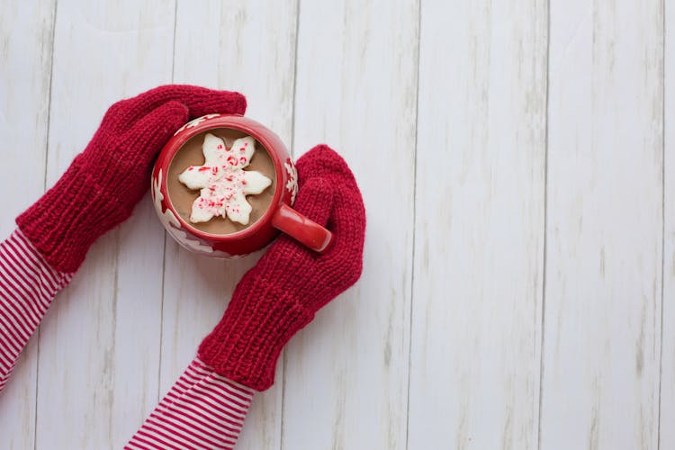 Person Wearing Red Gloves Holding Red And White Ceramic Mug