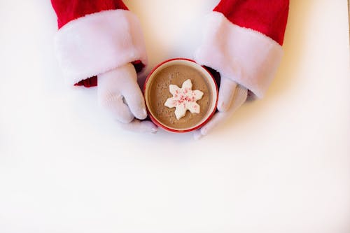 Free Person Wearing White Gloves Holding Cup of Hot Cocoa Stock Photo