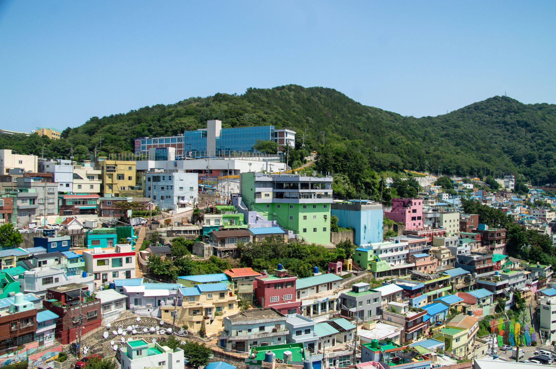 The pastel-coloured houses of Gamcheon Culture Village stacked up the green hillside in Busan