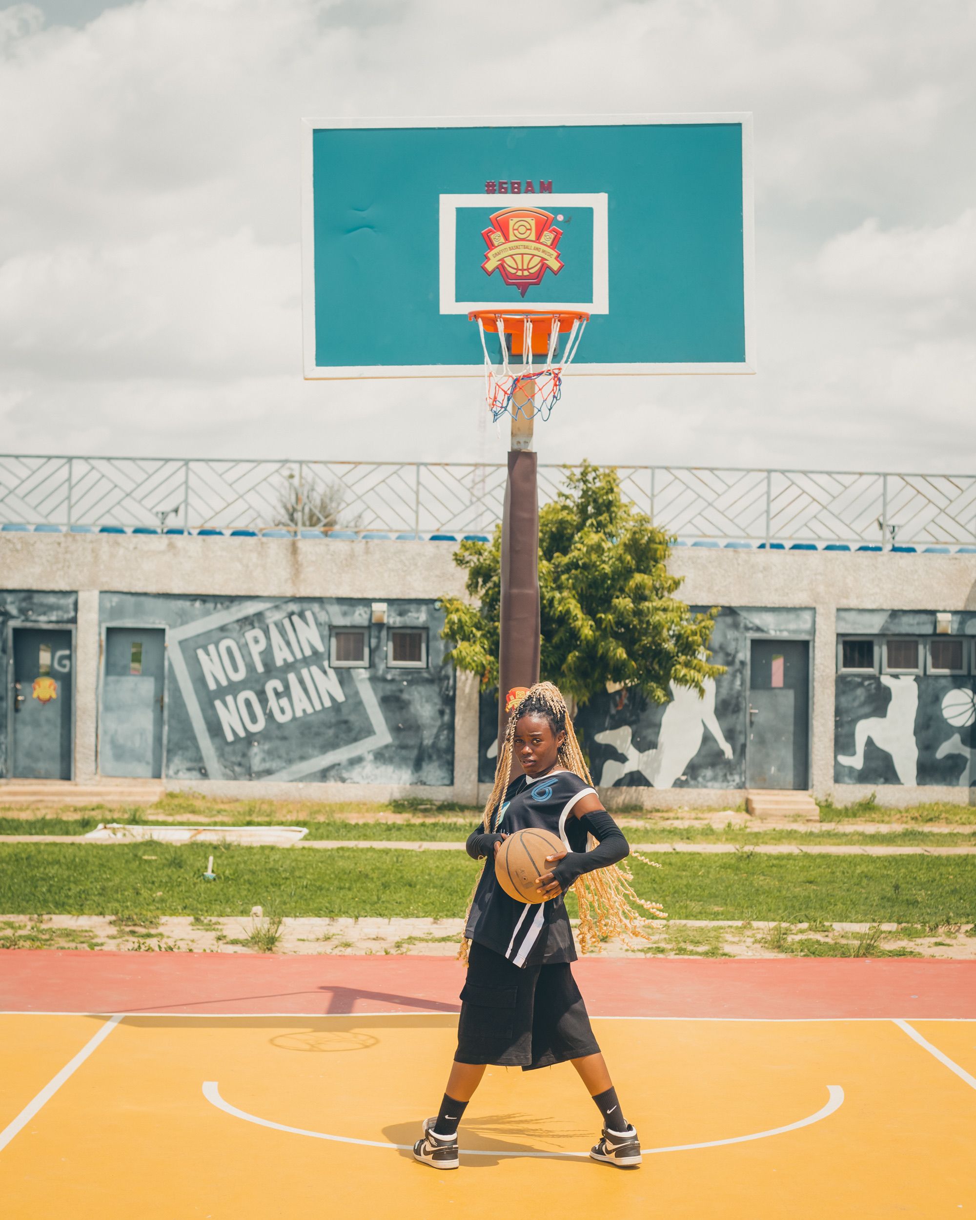Confident Young Woman on a Basketball Court · Free Stock Photo