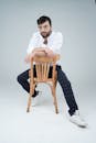 Casual Portrait of Man Sitting on Chair Backwards