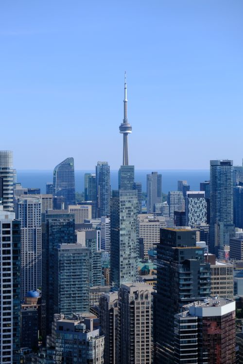Free A breathtaking daytime view of Toronto's skyline featuring the iconic CN Tower amid skyscrapers. Stock Photo