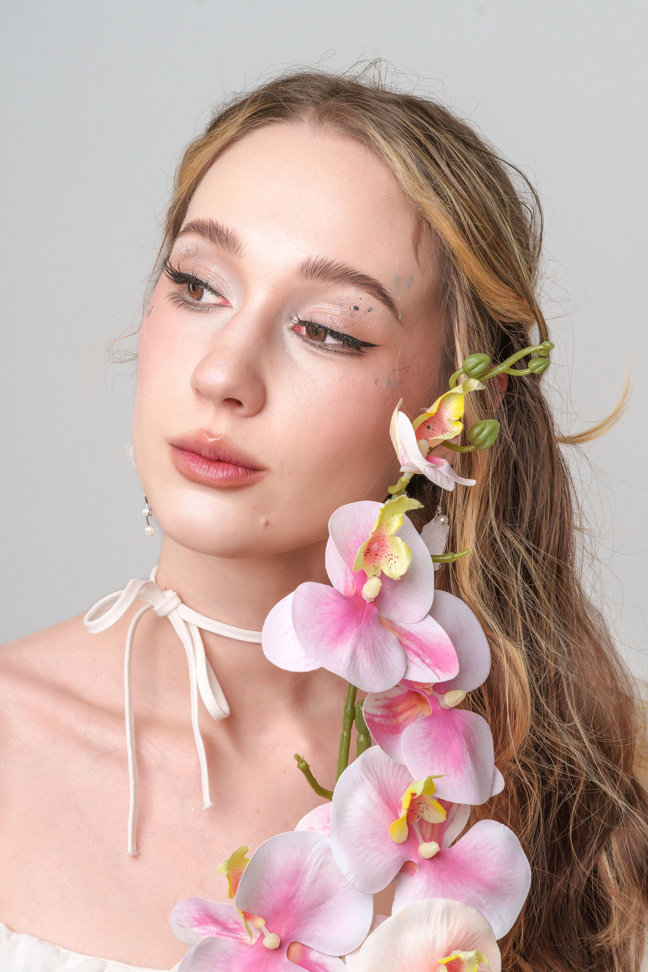 Elegant Portrait with Orchid Flowers · Free Stock Photo