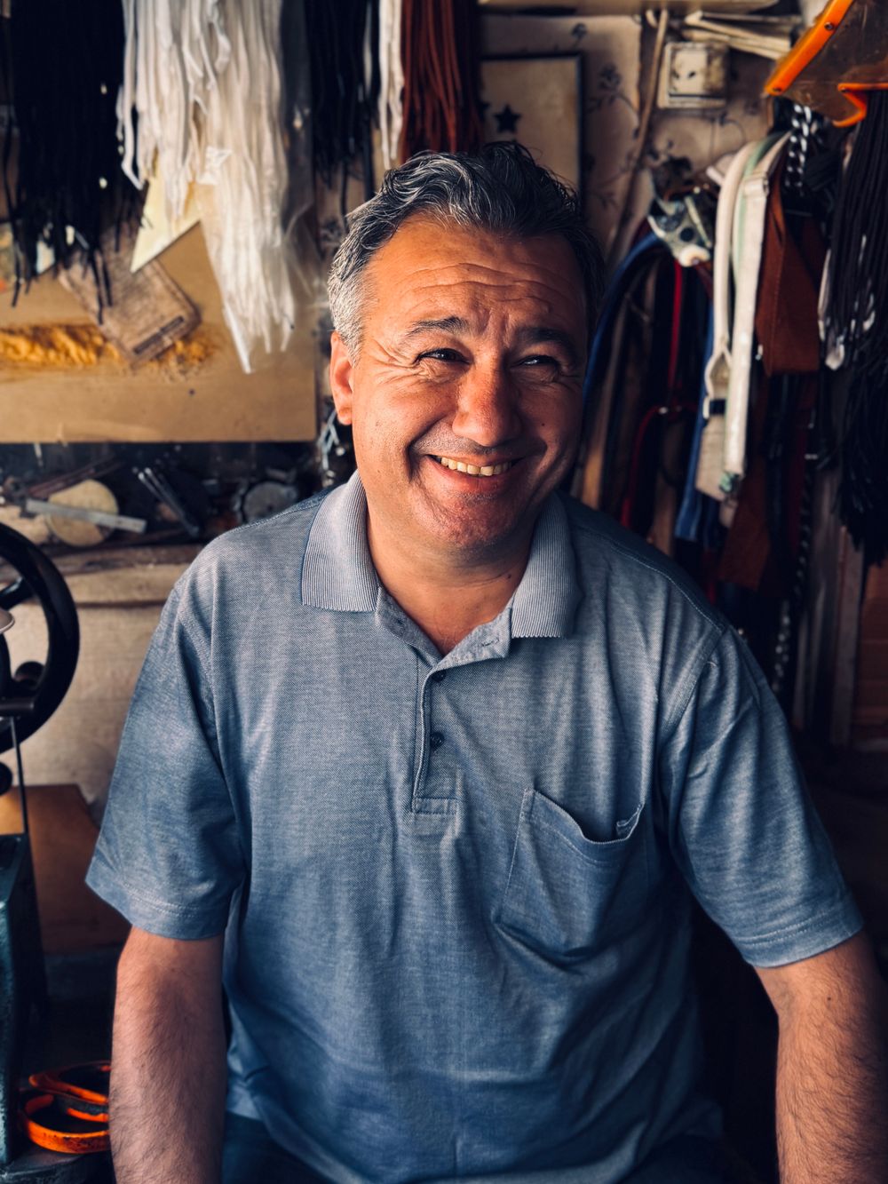 An artisan in the leather workshop surrounded by tools