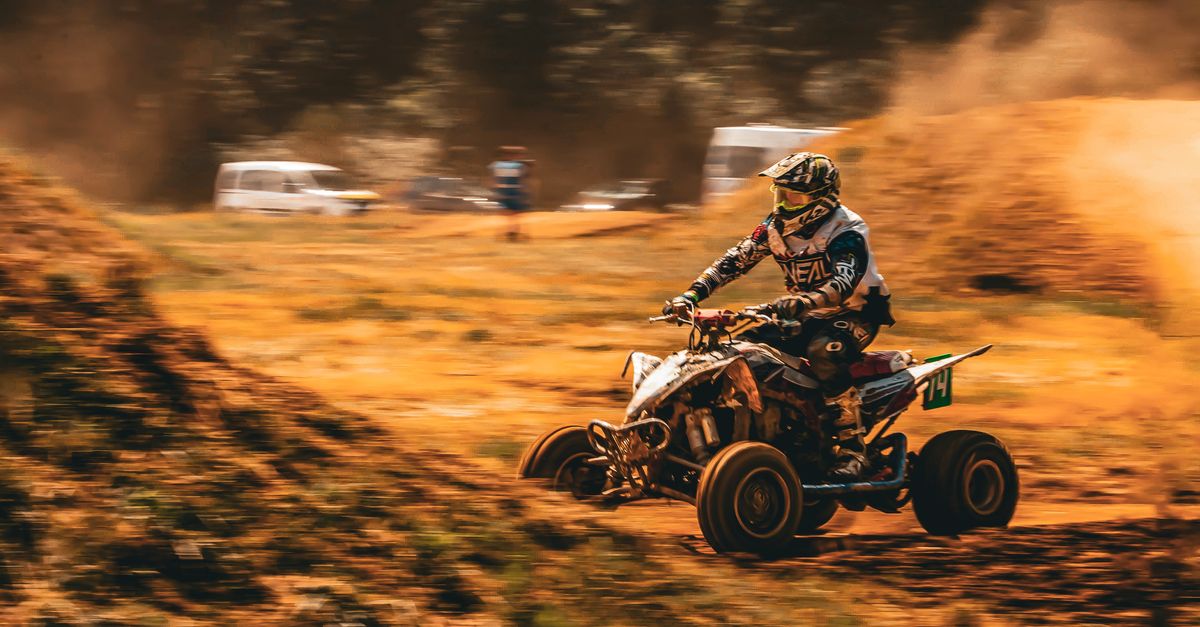 Dynamic Quad Bike Racing in Outdoor Terrain · Free Stock Photo