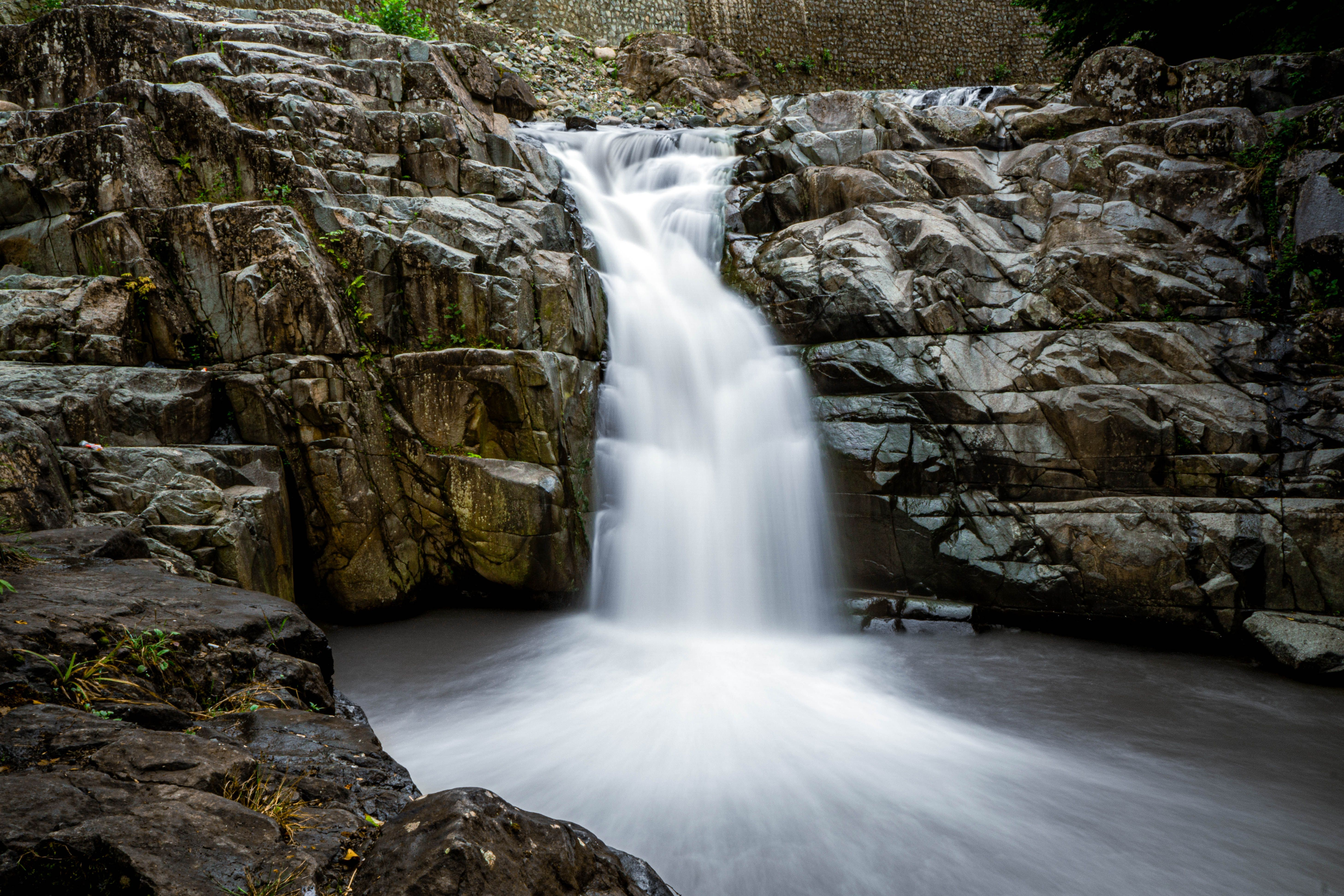Majestic Waterfall Cascading Over Rocky Cliffs · Free Stock Photo