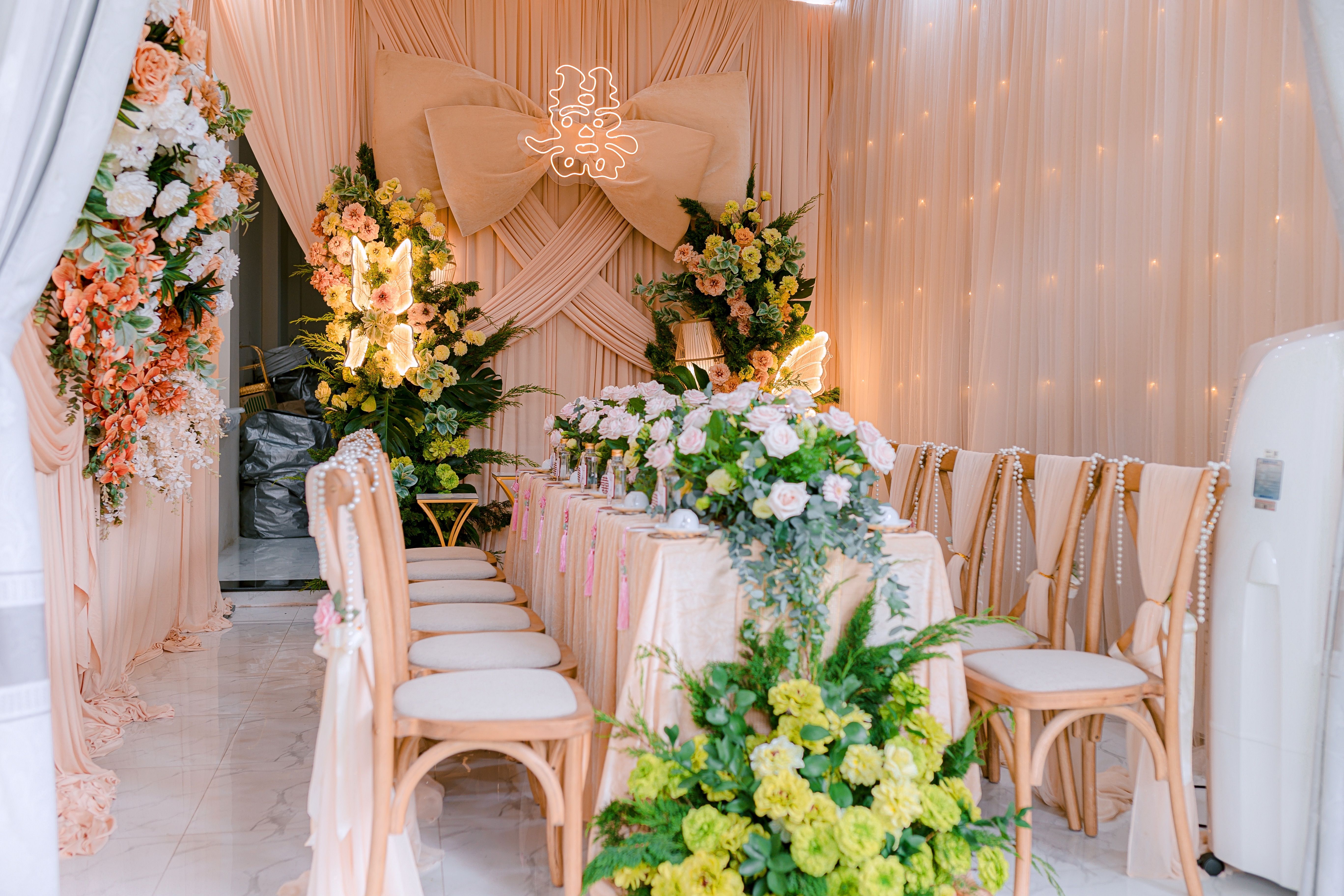 Luxurious indoor wedding table setup with exquisite floral arrangements and elegant decor.