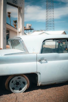 A nostalgic image of a classic car in a vintage setting on Route 66 in California.