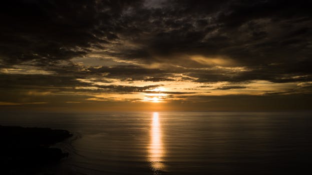 Experience the serene beauty of a dramatic sunrise over the ocean in Bali, Indonesia. Perfect for capturing atmospheric light.