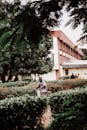 Cyclist in Lush Green Campus Setting