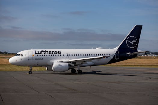 Lufthansa Airbus A319 on an airport tarmac under clear skies, ready for departure.