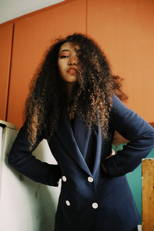 Woman With Curly Hair Wearing Blue Blazer
