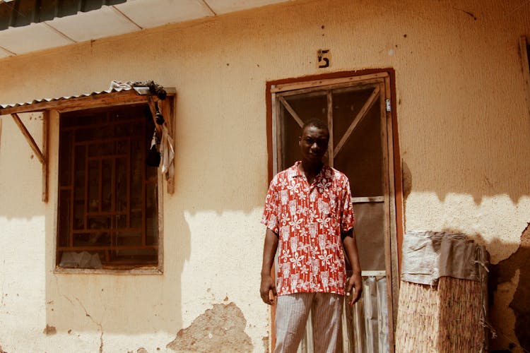 Photo Of Man Standing Beside Door