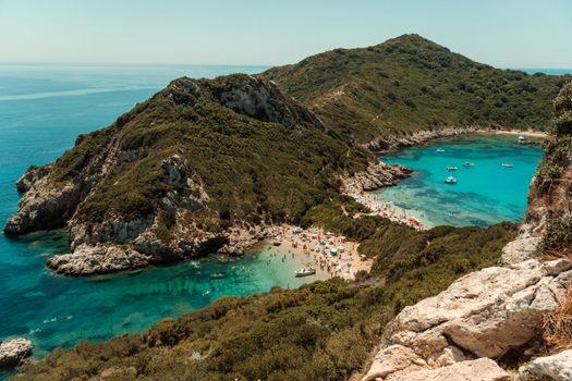 Breathtaking aerial shot of Porto Timoni Beach with turquoise waters and lush greenery in Corfu, Greece.