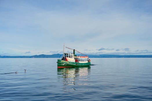 A vibrant boat on the serene waters of Lake Taupō, capturing the tranquil beauty and adventure of New Zealand.