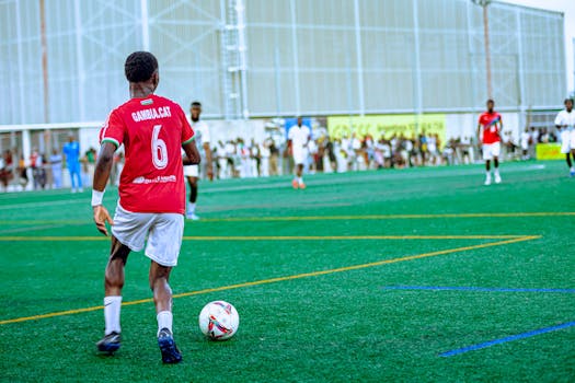 Action shot of a soccer player during a match on a bright, sunny day.