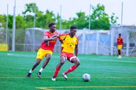 Players engage passionately in a soccer match on an outdoor field, showcasing athleticism and team spirit.