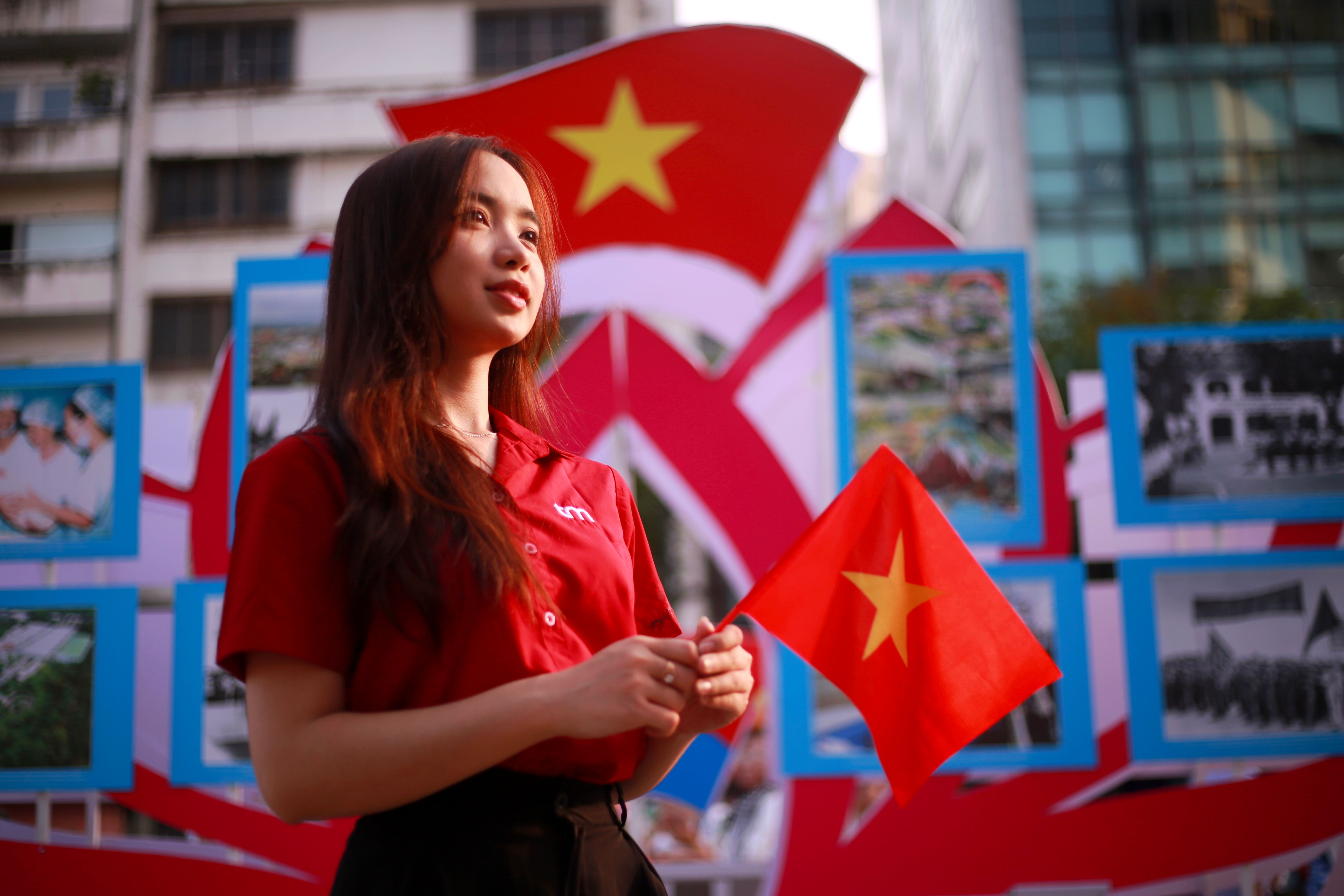 Young Woman Holding Vietnamese Flag in Ho Chi Minh City · Free Stock Photo