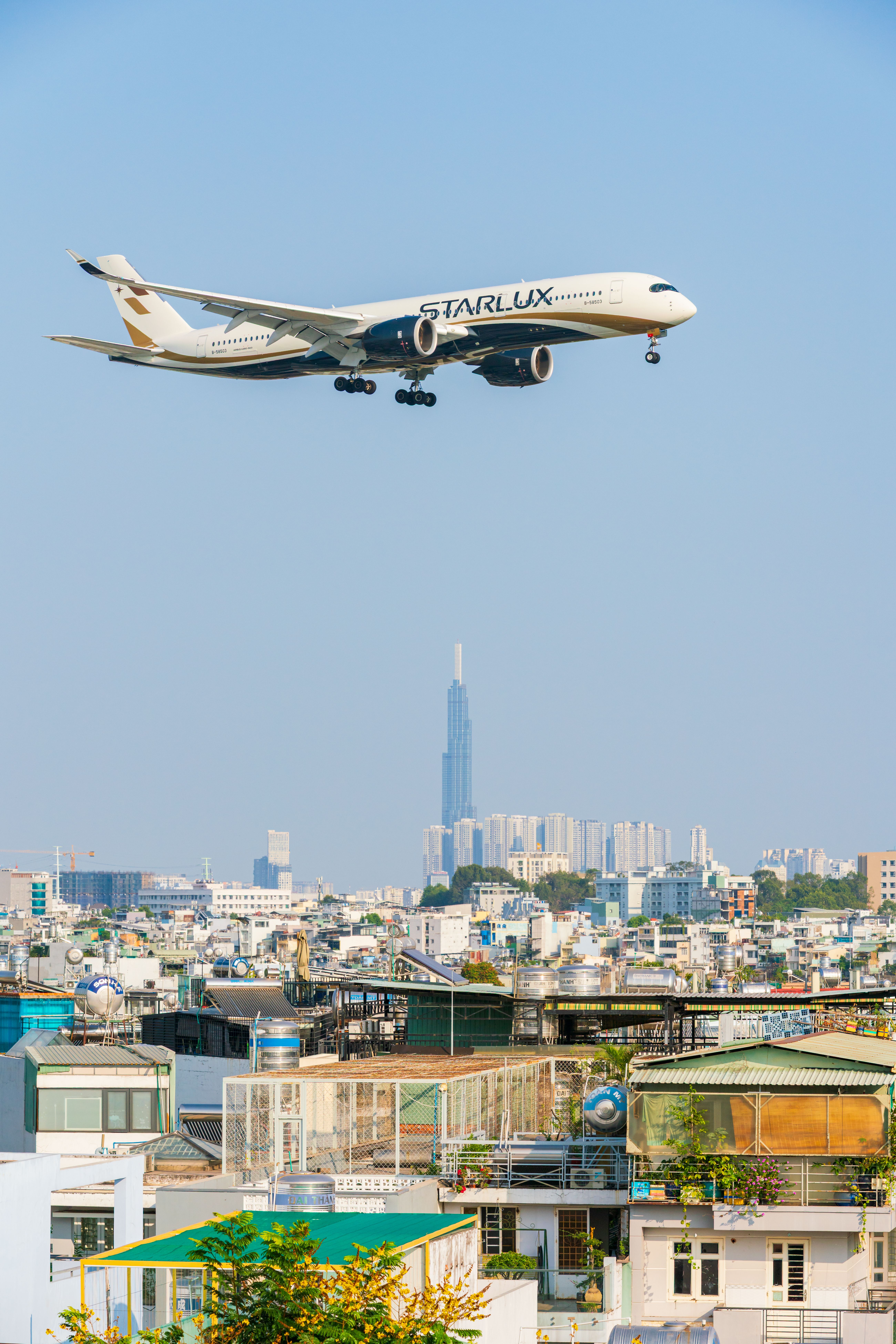 Airplane Flying over Ho Chi Minh City Skyline · Free Stock Photo