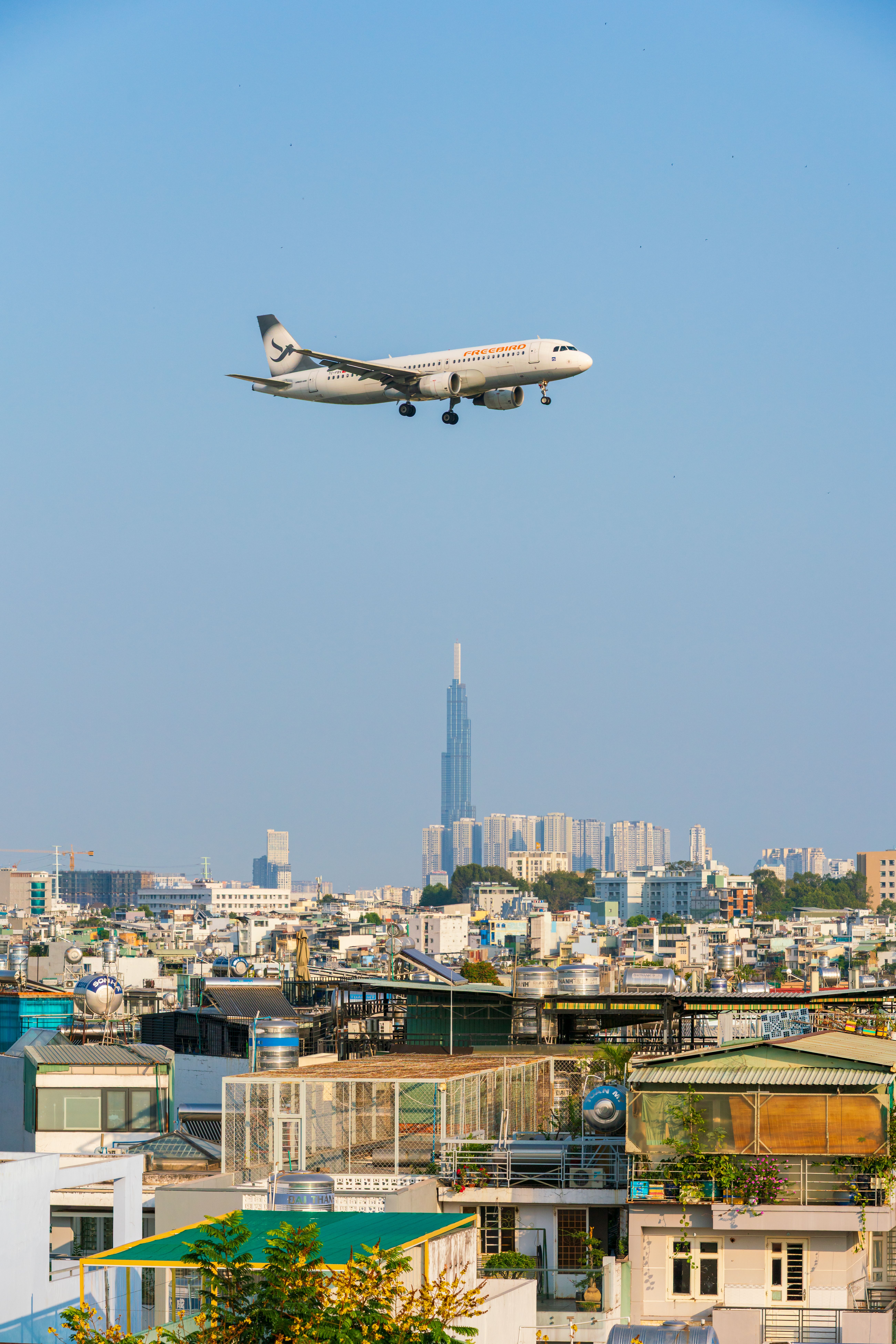 Airplane Flying Over Ho Chi Minh City Skyline · Free Stock Photo