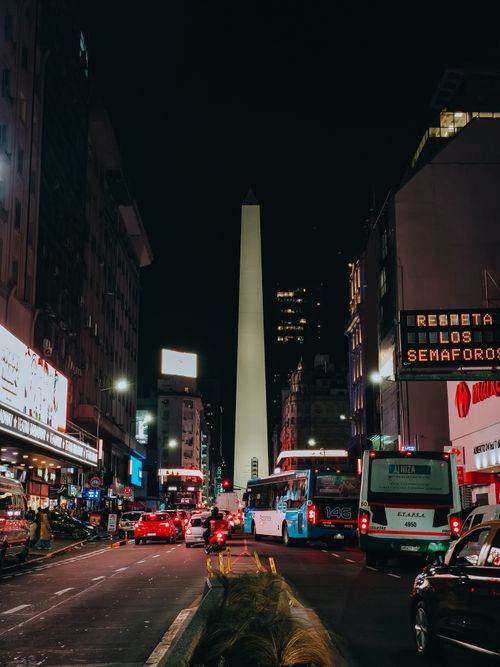 Free Nighttime view of Buenos Aires city traffic with the iconic Obelisk landmark. Stock Photo