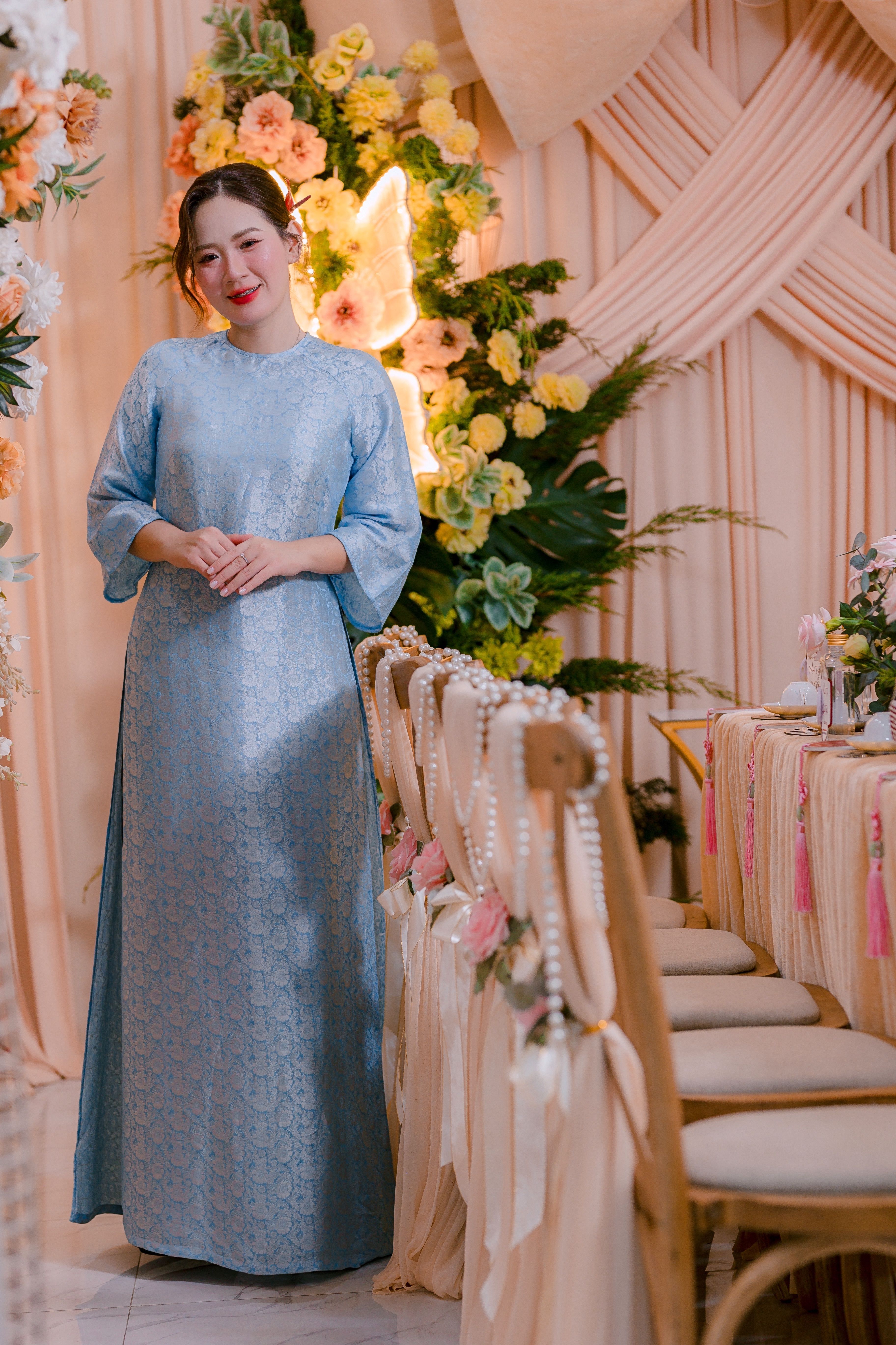 Elegant Woman in Blue Dress at Floral Event · Free Stock Photo