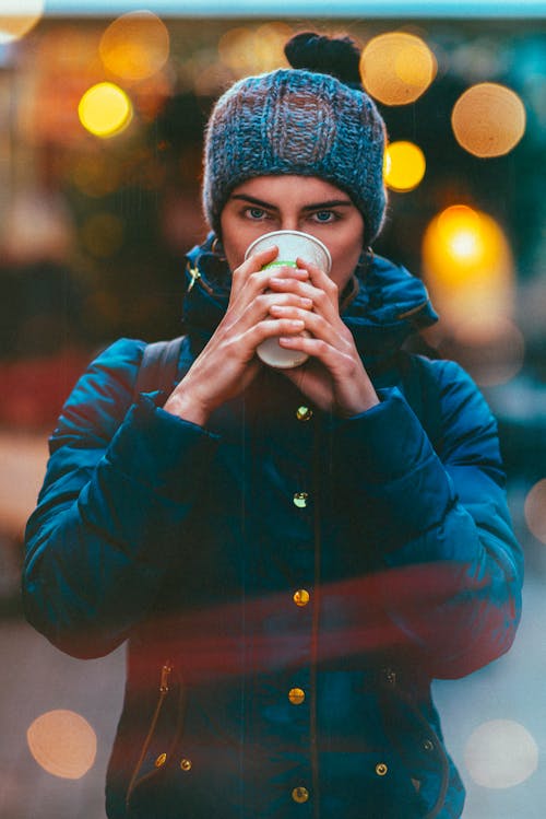 Photo Of Woman Holding White Cup