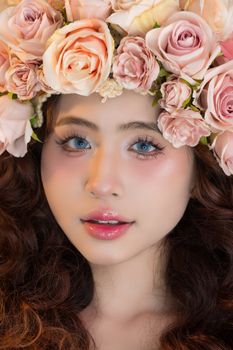 Stunning portrait of a woman with a beautiful floral crown of roses.